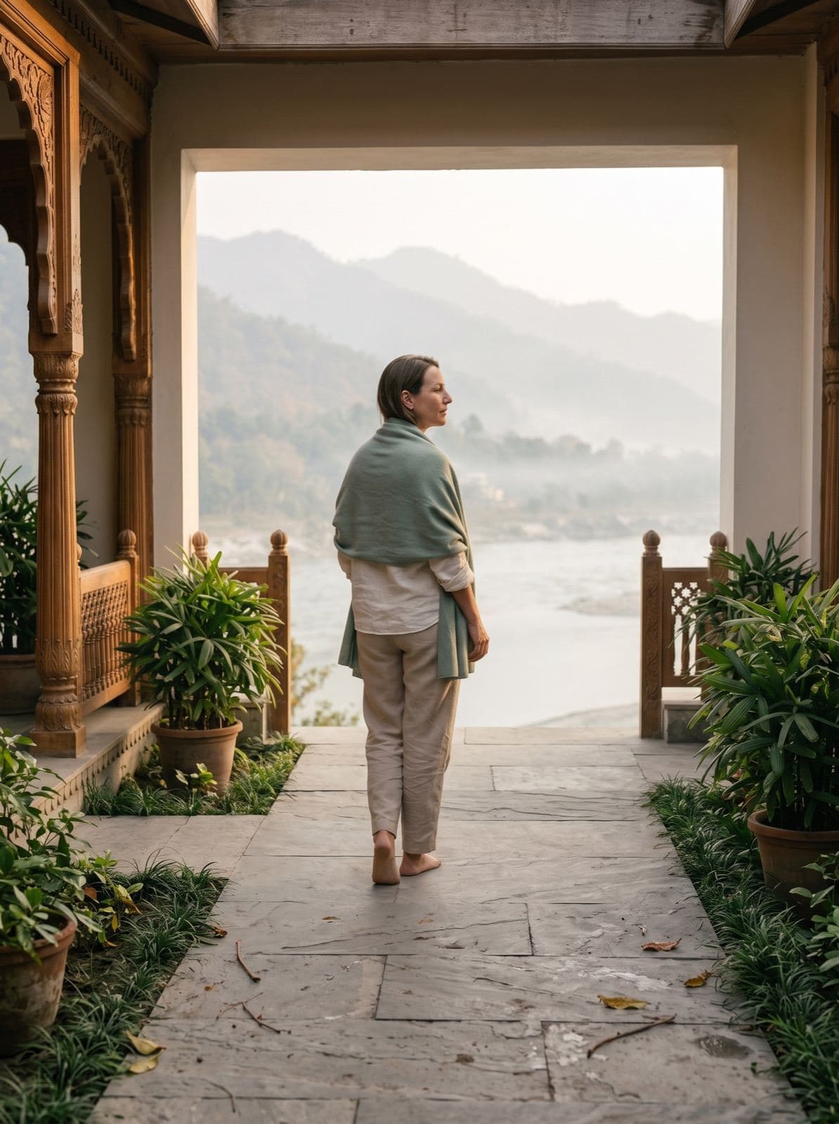 Guest arriving into a calm Ganga-side retreat setting in Rishikesh